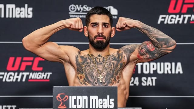 Ilia Topuria poses for the cameras during UFC weigh-ins.